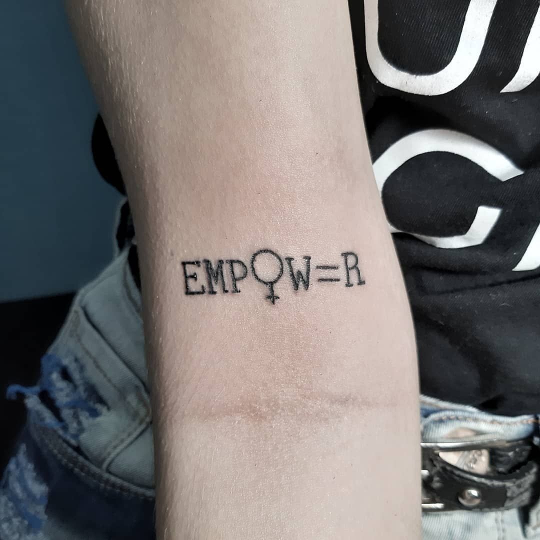 raised hand making a fist gesture of power with a feminist feminism logo  wrist tattoo, woman power concept isolated on a white background Stock  Photo | Adobe Stock