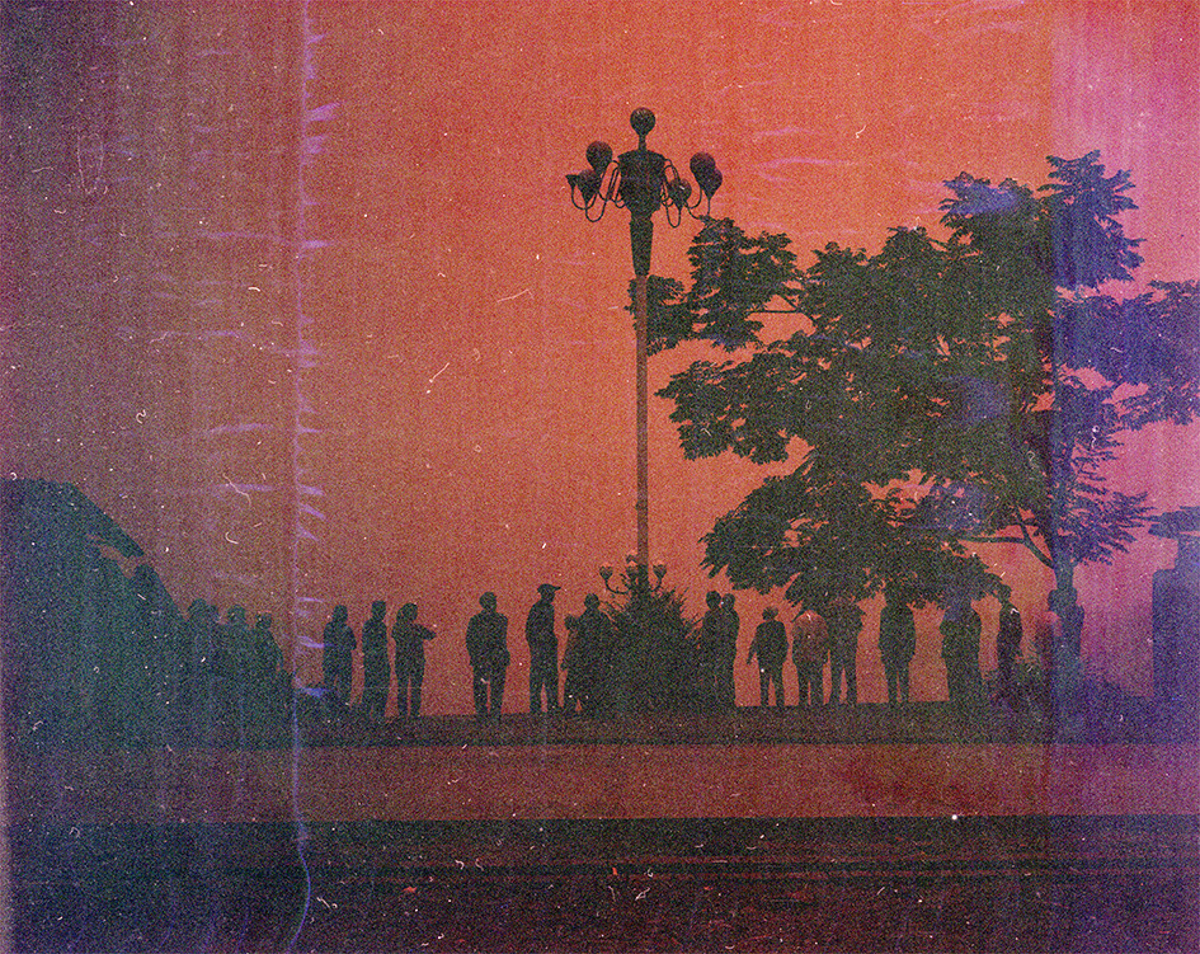 Image showing the silhouettes of a line of people, a tree and a lamppost. The scene is overlaid with a red hue.