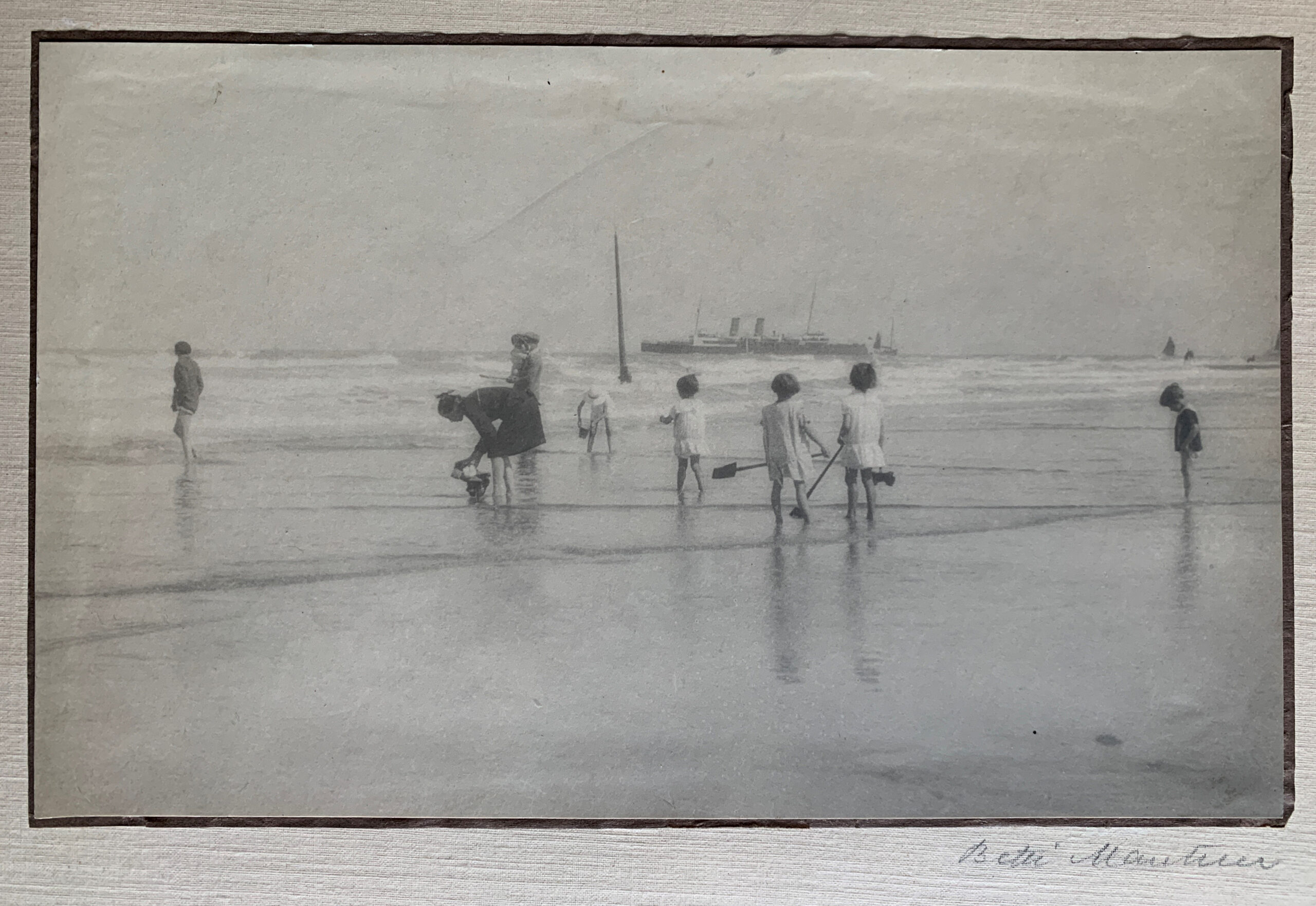 A Misty Morning Beach Gossip, 1919 by Betti Mautner © James Hyman. Children with spades are digging at the waters edge of the beach.