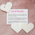 Three seed hearts with sowing instructions on plush pink fabric