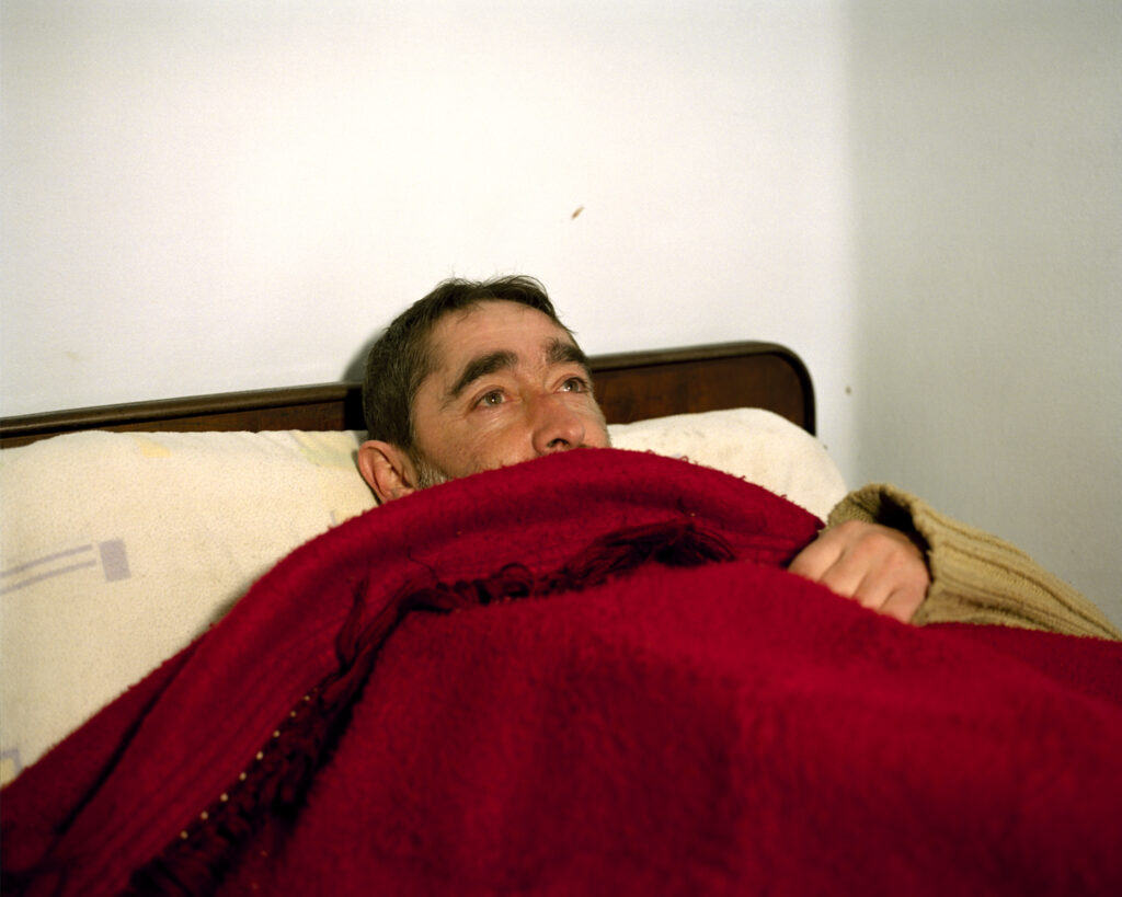 Man in bed, Pension la Parra, Ferrol, Galicia, Spain. 2018 © Lua Ribeira / Magnum Photos