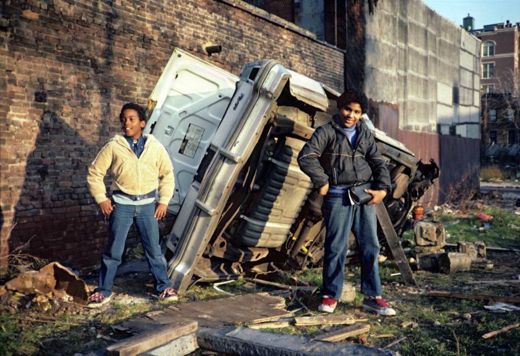 Boys Pose in Front of Car Wreck