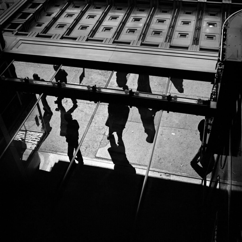 Black and white photo. Abstract composition of shadows on a pavement.