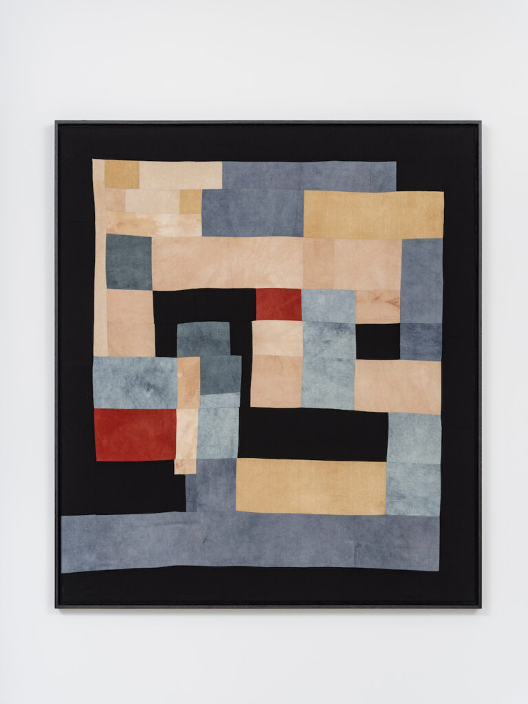 Fabric collage by Yto Barrada. Pink, navy blue, red, and black squares are arranged in a rectangle.