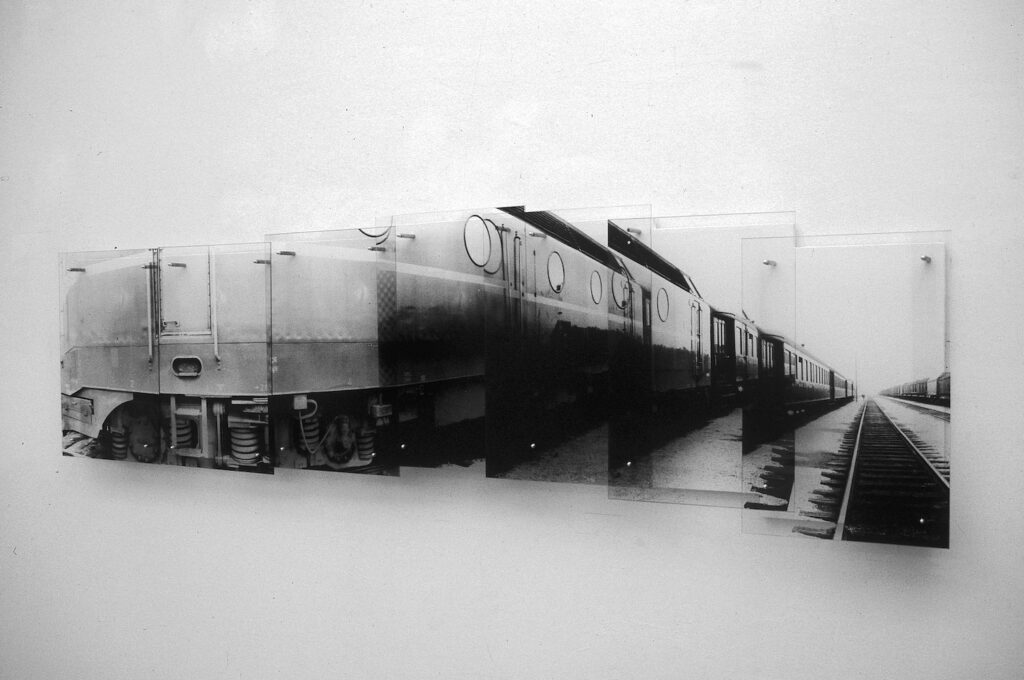 Black and white photographs depicting sections of a train. The individual photos combine into a single image.