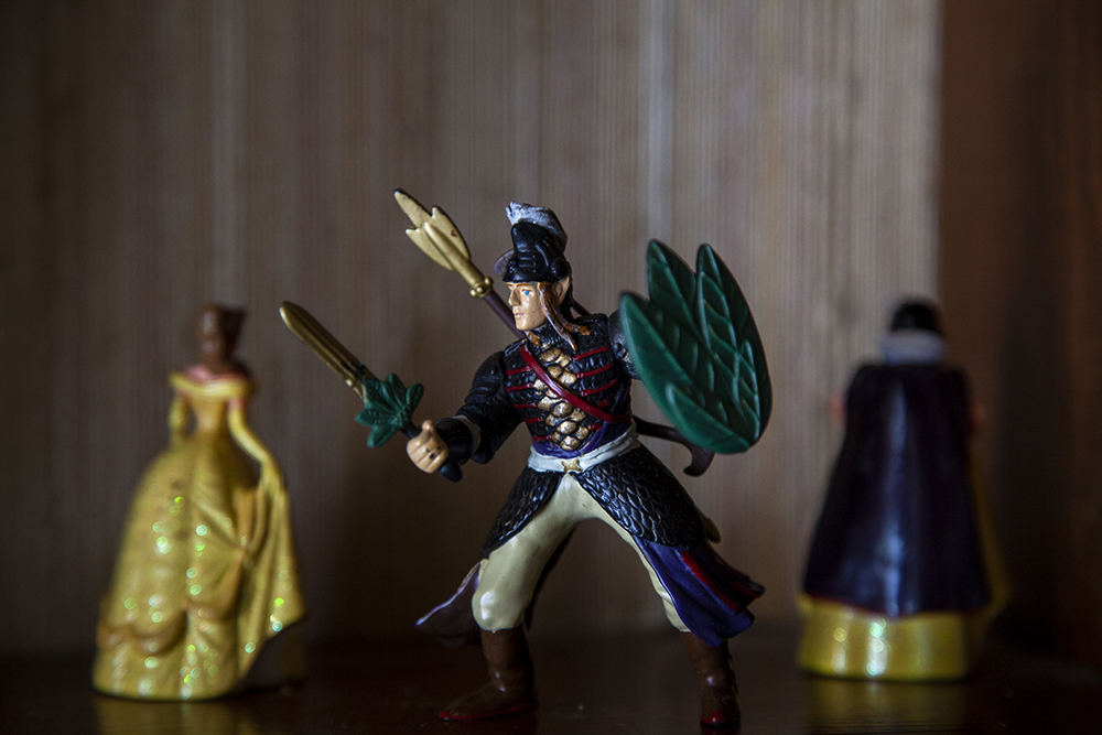 A figurine of a soldier, in front of distance figurines of Disney's versions of Belle and Snow White.