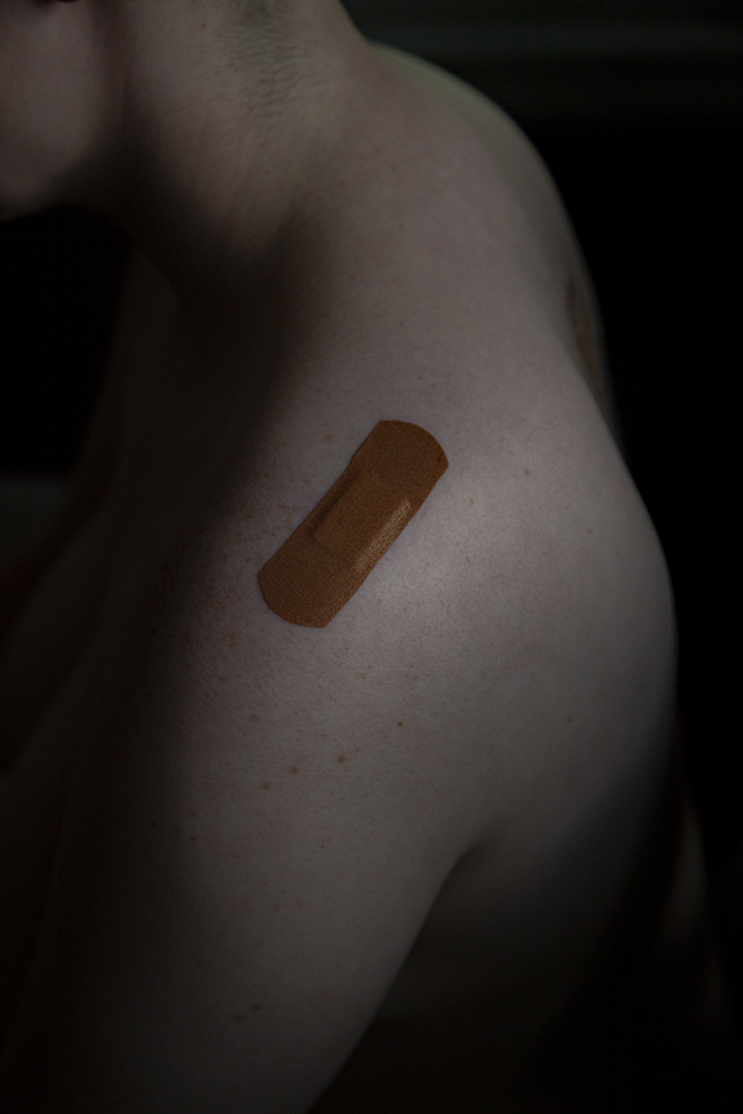 A plaster on Alex's shoulder.