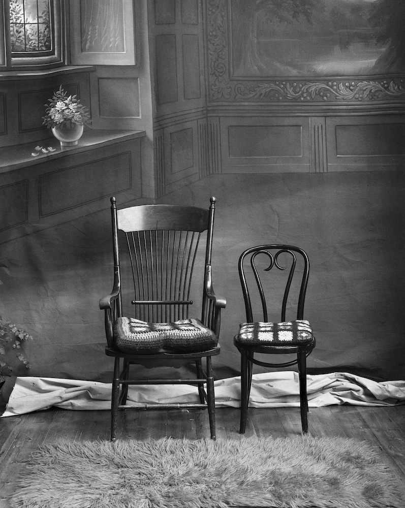 Black and white photograph of two wooden chairs.