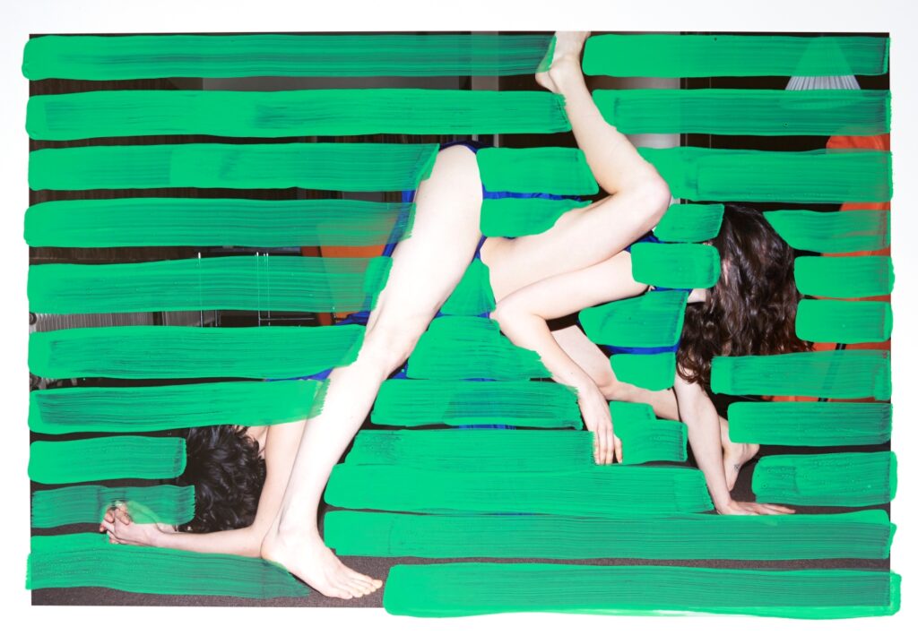Green painted lines almost totally cover a photograph of two people, contorting and fragmenting their bodies.