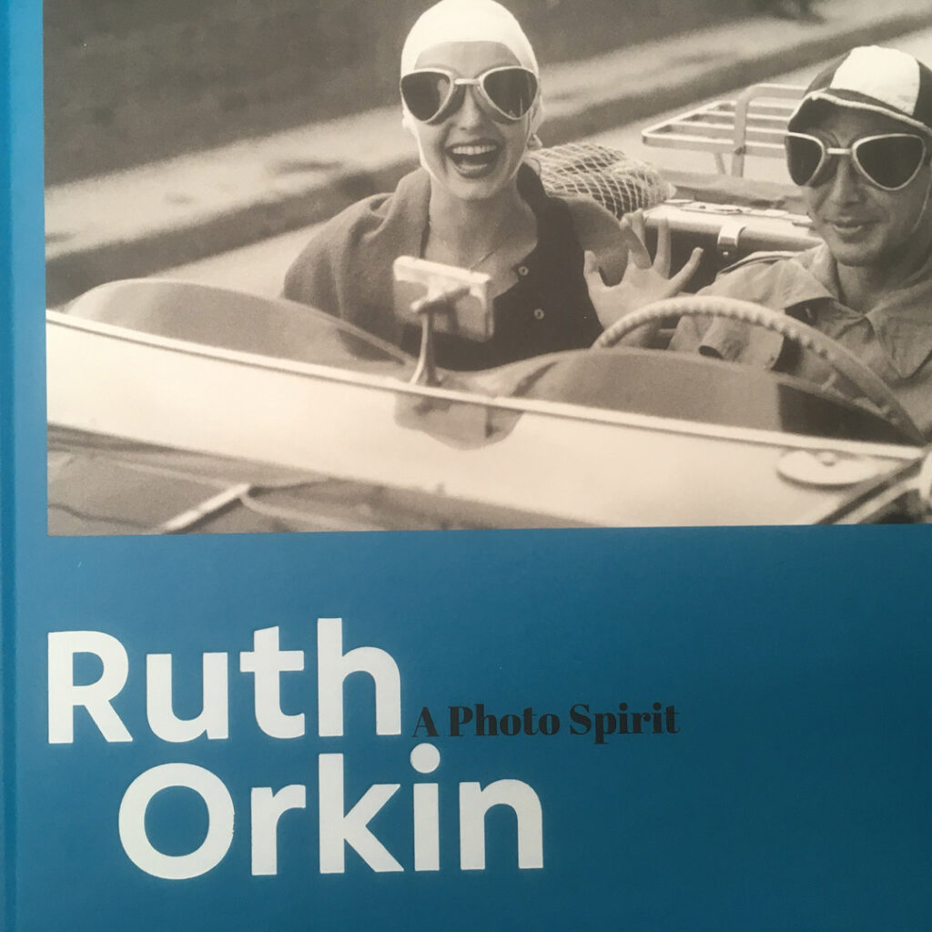 Blue cover of book by Ruth Orkin showing a man and a woman in a sports car